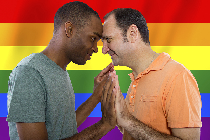 Interracial Gay Couple with Rainbow Flag Interracial Gay Couple with Rainbow Flag